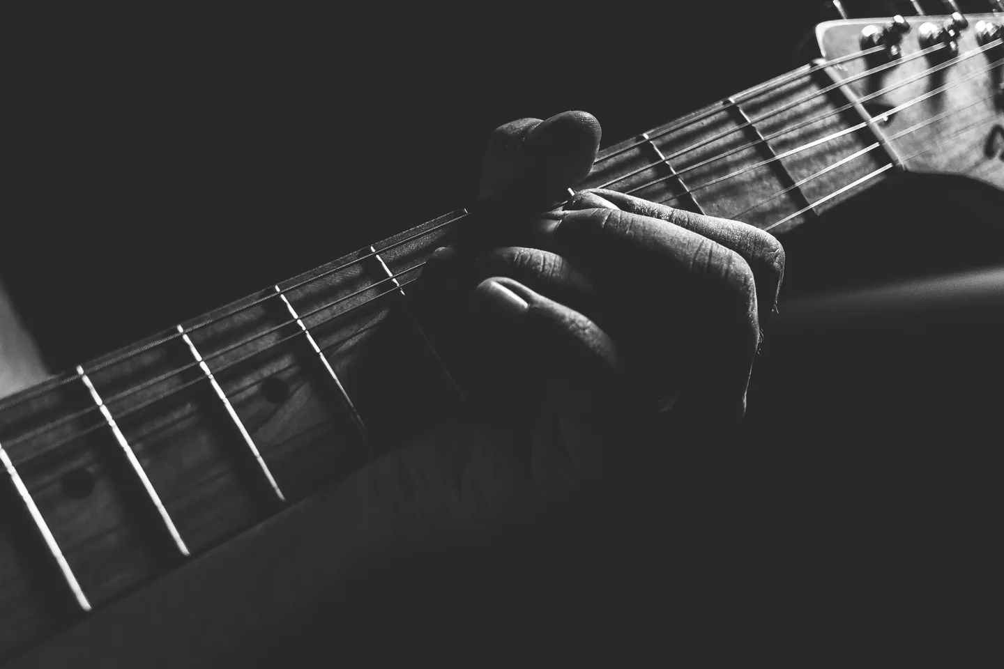 Electric guitar and string instruments displayed in a music setting